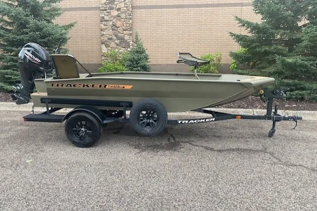The Image of 2027 Tracker Grizzly 1553 Timber boat on trailer, parked outdoors. - 0