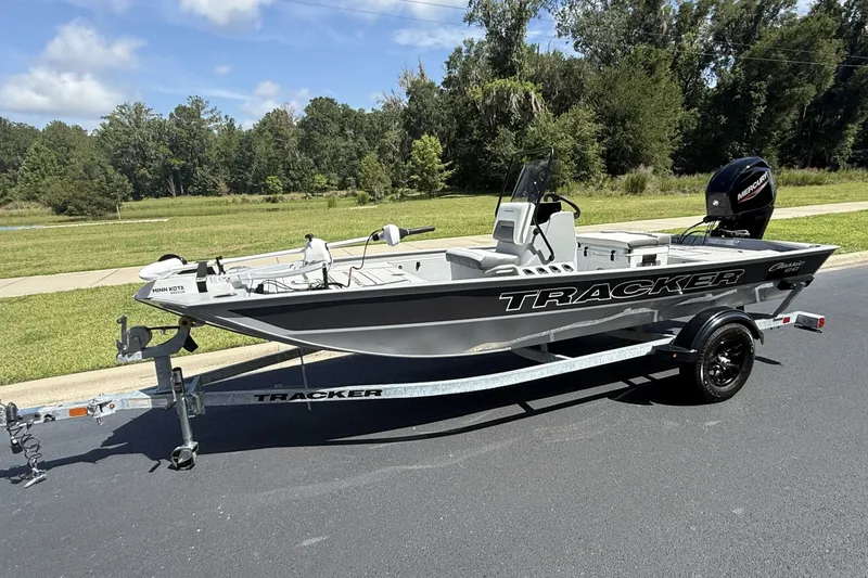 The Image of 2027 Tracker Bass Tracker Classic CC boat on trailer, parked outdoors. - 0