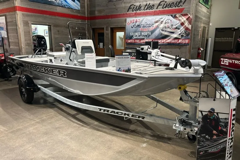 The Image of 2027 Tracker Bass Tracker Classic CC boat displayed in showroom with promotional banners. - 0