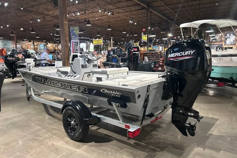 Slide: The Image of 2027 Tracker Bass Tracker Classic CC boat with Mercury engine in showroom. - 13