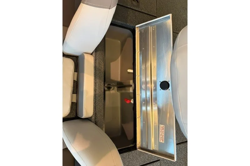 Slide: The Image of 2027 Tracker Pro Team 175 boat storage compartment with open lid and seating. - 15