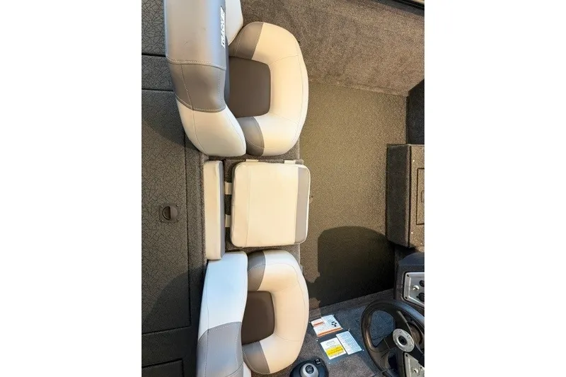 Slide: The Image of 2027 Tracker Pro Team 175 boat interior with cushioned seating and steering wheel. - 14