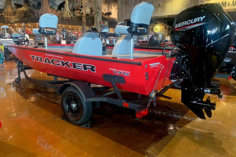 The Image of Red 2027 Tracker Pro Team 175 boat with Mercury engine displayed indoors. - 0