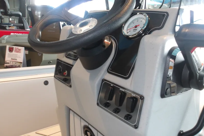 Slide: The Image of 2027 Tracker Bass Tracker Classic CC console with steering wheel and RPM gauge. - 16