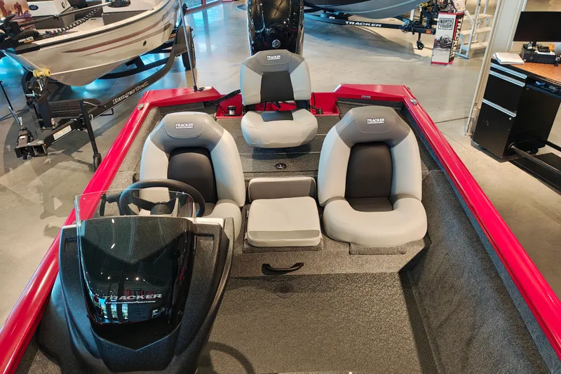 Slide: The Image of 2027 Tracker Pro Team 175 boat interior with seating and steering console in showroom. - 21