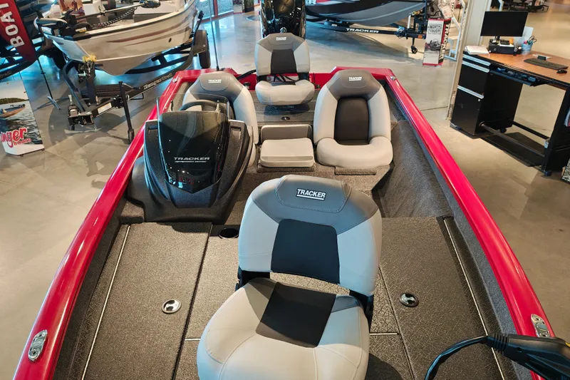 Slide: The Image of 2027 Tracker Pro Team 175 boat interior with gray seats and red accents in showroom. - 20