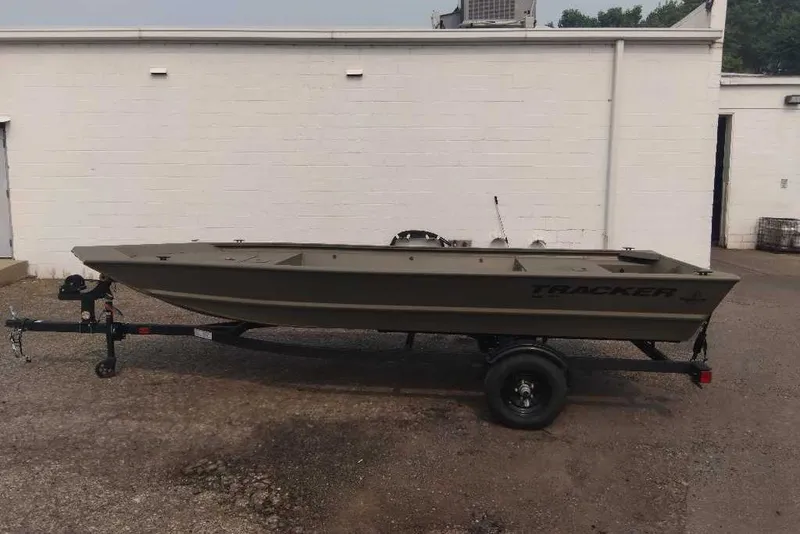 The Image of 2027 Tracker Grizzly 1648 Utility boat on trailer, parked outdoors. - 0