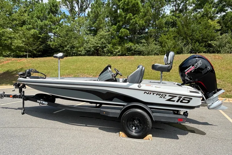 Slide: The Image of 2027 Nitro Z18 XL boat with Mercury engine, parked on a trailer in a scenic outdoor setting. - 4