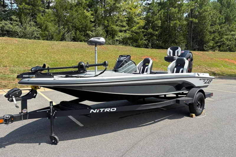 Slide: The Image of 2027 Nitro Z18 XL fishing boat on trailer, parked outdoors. - 2