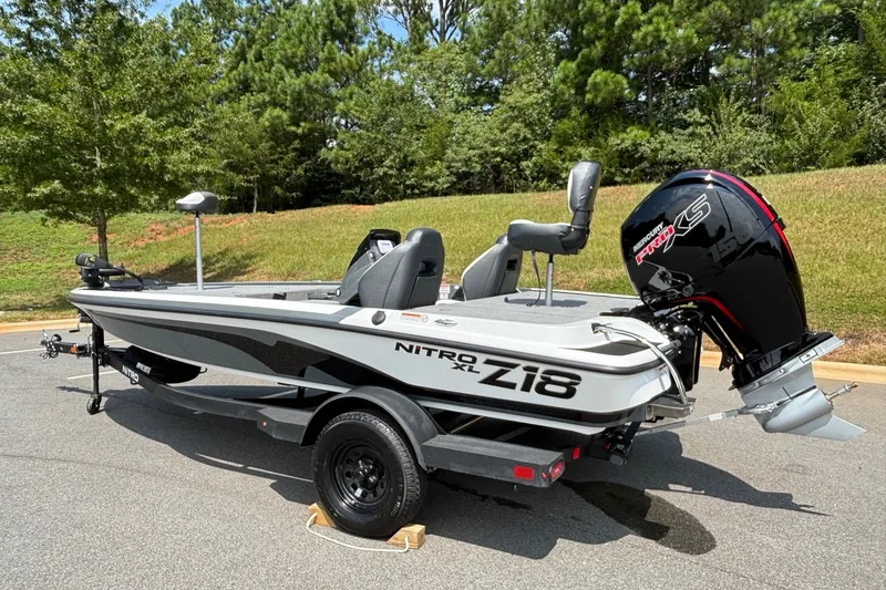 Slide: The Image of 2027 Nitro Z18 XL boat with Mercury Pro XS engine on a trailer, parked outdoors. - 5