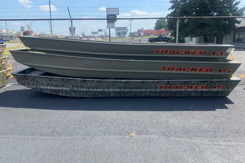 The Image of 2027 Tracker Grizzly 15 Jon boats stacked outdoors on pavement. - 0