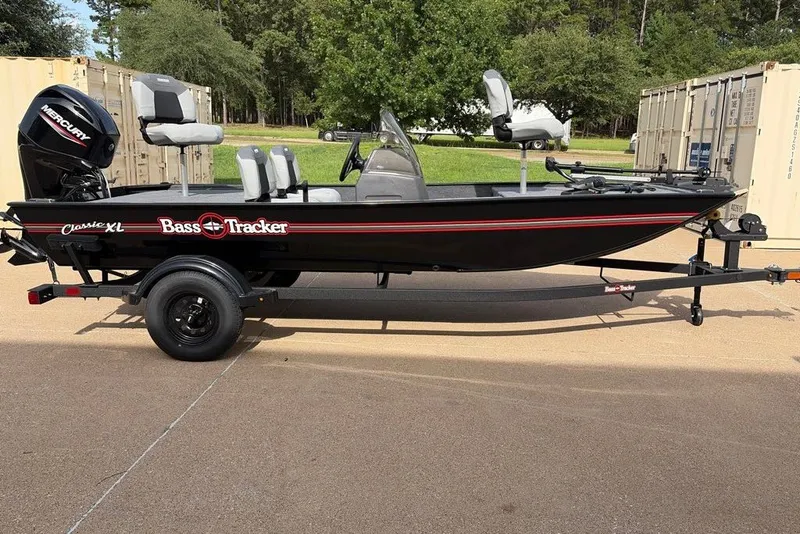 The Image of 2027 Tracker Bass Tracker Classic XL boat on trailer, parked outdoors. - 0
