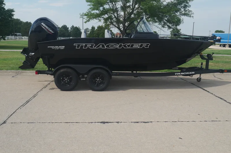 The Image of 2027 Tracker Pro Guide V-175 Combo boat on trailer, parked outdoors. - 0