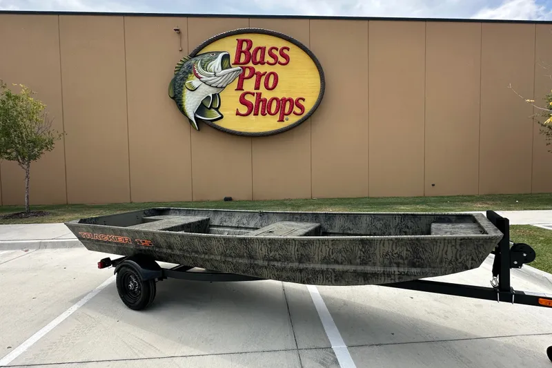 The Image of 2027 Tracker Grizzly 15 Jon boat on trailer outside Bass Pro Shops. - 1
