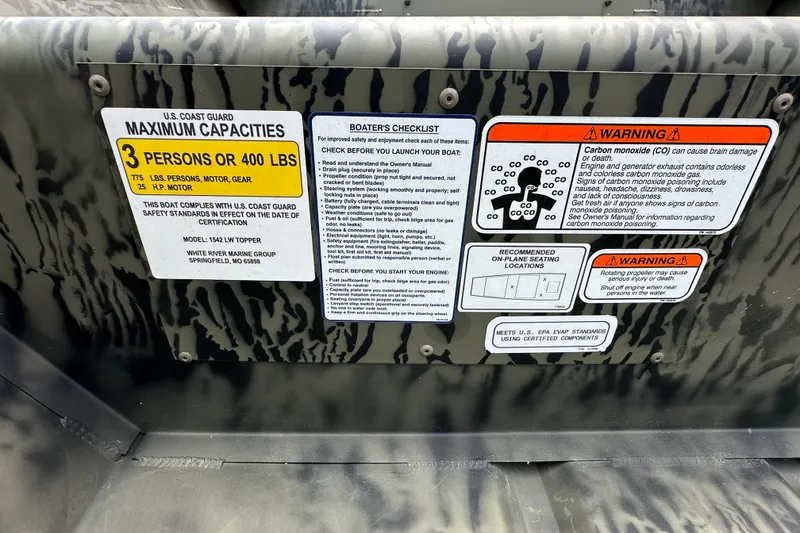 Slide: The Image of Boat safety labels on a 2027 Tracker Grizzly 15 Jon, detailing capacity and warnings. - 15