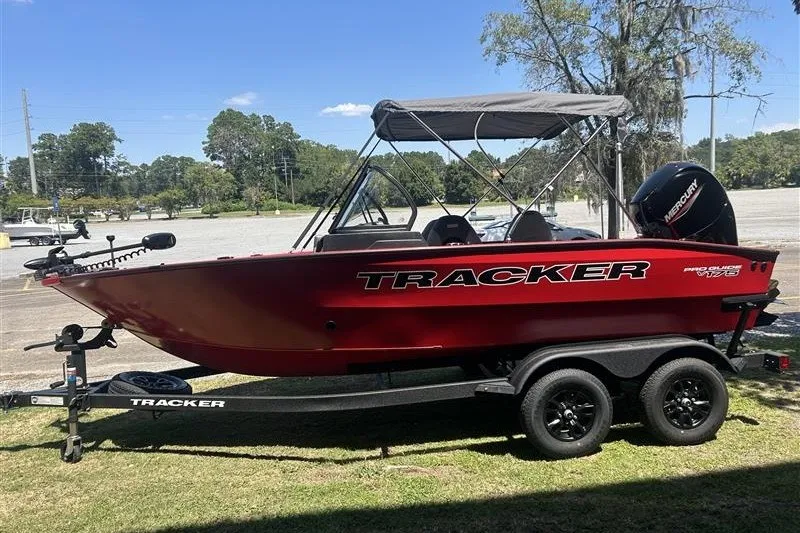 The Image of 2027 Tracker Pro Guide V-175 Combo boat on trailer, parked outdoors. - 0