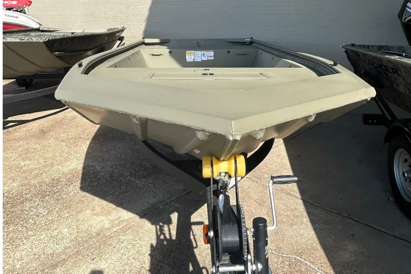 The Image of 2027 Tracker Grizzly 1648 Utility boat on trailer, displayed outdoors. - 0