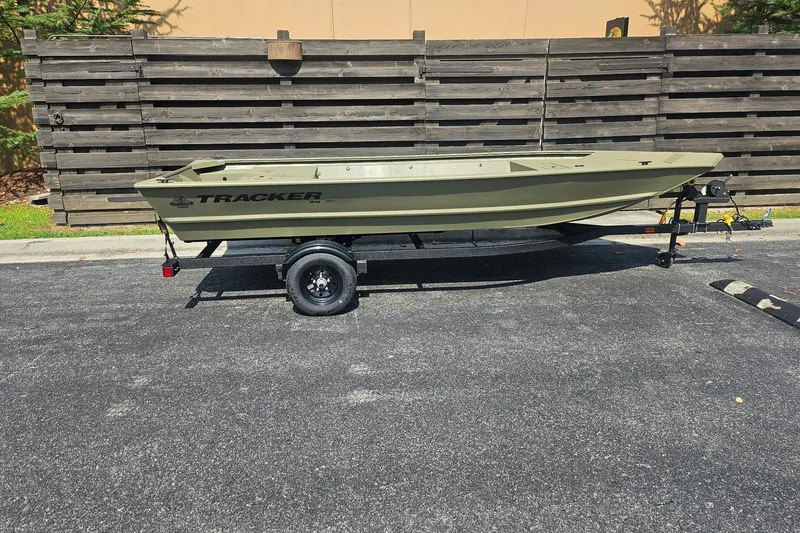 The Image of 2027 Tracker Grizzly 1648 Utility boat on trailer, parked outdoors. - 0