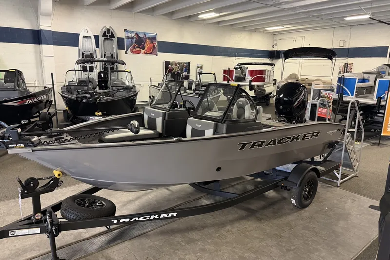 The Image of 2027 Tracker Pro Guide V-175 Combo boat displayed in showroom on trailer. - 0