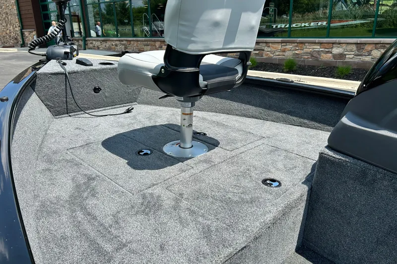 Slide: The Image of 2027 Tracker Super Guide V-16 SC boat interior with swivel seat and carpeted deck. - 13