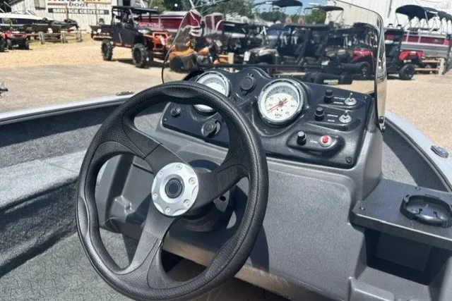 Slide: The Image of Steering console of 2027 Tracker Super Guide V-16 SC boat with gauges and controls. - 36