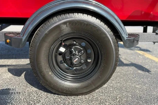 Slide: The Image of Trailer wheel of a 2027 Tracker Pro 170, featuring a black Load Star tire. - 14