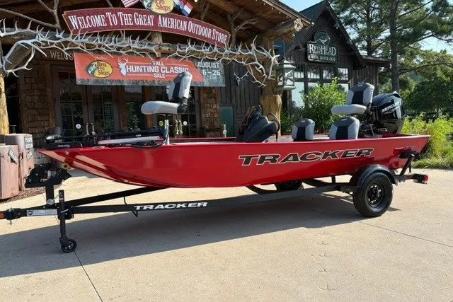 The Image of Red 2027 Tracker Pro 170 boat on trailer outside outdoor store. - 0