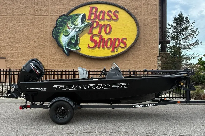 The Image of 2027 Tracker Super Guide V-16 SC in front of a Bass Pro Shops building. - 0