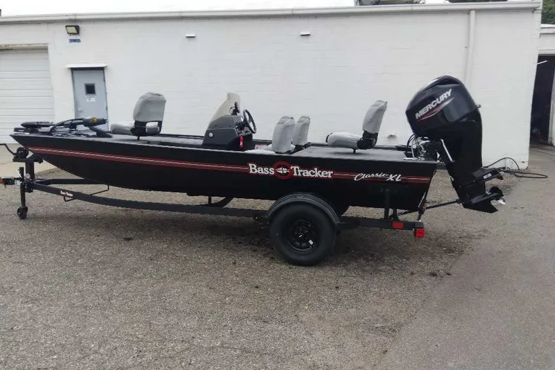 The Image of 2027 Tracker Bass Tracker Classic XL boat with Mercury engine, parked outside a building. - 0