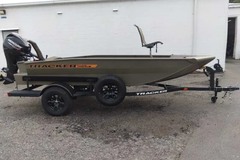 The Image of 2027 Tracker Grizzly 1553 Timber boat on trailer, featuring a Mercury outboard motor. - 0