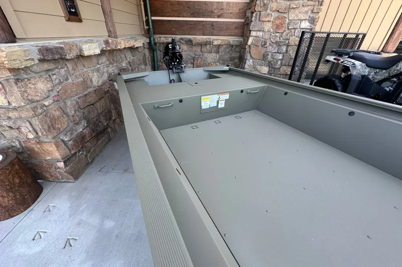 Slide: The Image of 2027 Tracker Grizzly 1648 Utility boat in a rustic setting, showcasing its spacious interior. - 22