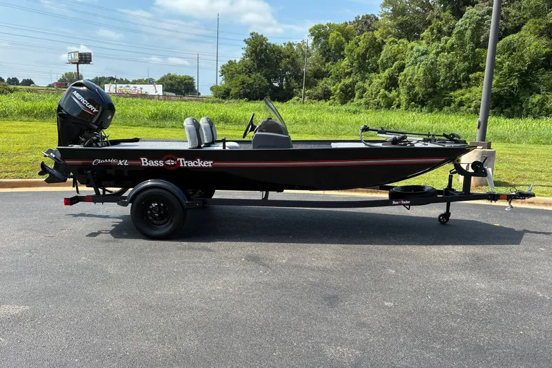 The Image of 2027 Tracker Bass Tracker Classic XL boat on trailer, parked outdoors. - 0