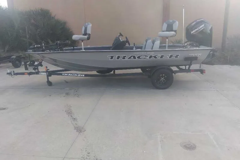 The Image of 2027 Tracker Pro Team 175 boat on trailer, parked outdoors. - 0