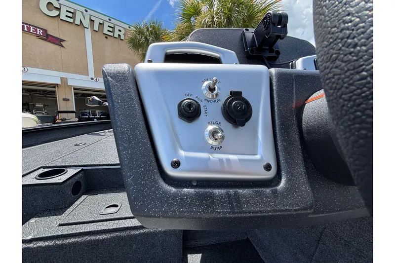 Slide: The Image of Control panel of a 2027 Tracker Pro Team 175 boat with switches and outlets. - 13