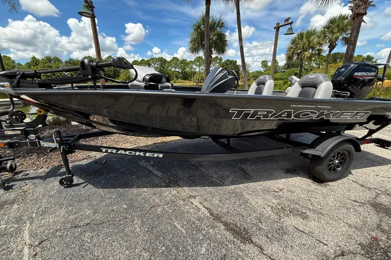 The Image of 2027 Tracker Pro Team 175 boat on trailer, parked outdoors under a clear sky. - 0