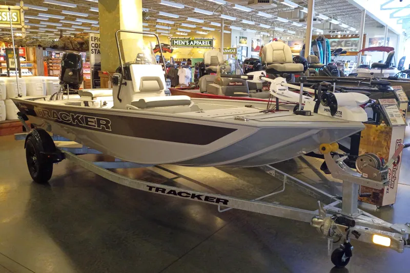The Image of 2027 Tracker Bass Tracker Classic CC boat displayed indoors on a trailer. - 0