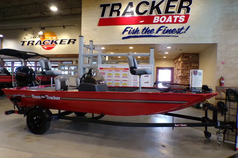 The Image of 2027 Tracker Bass Tracker Classic XL boat displayed in showroom with promotional signage. - 0