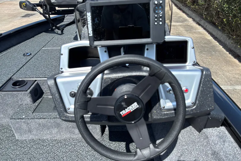 Slide: The Image of 2027 Tracker Pro Team 175 boat dashboard with steering wheel and navigation system. - 14