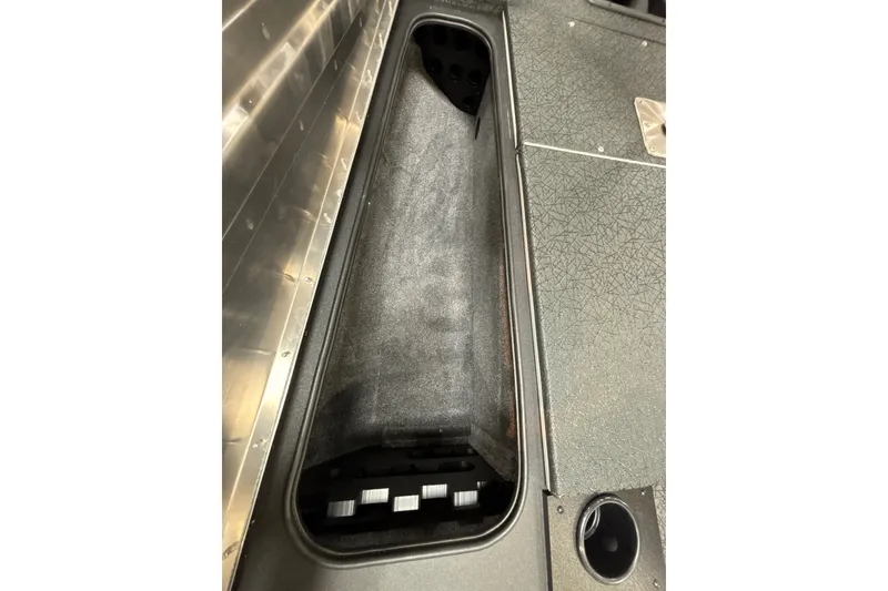 Slide: The Image of 2027 Tracker Pro Team 175 boat storage compartment with textured interior. - 23