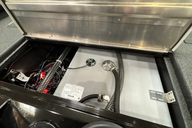 Slide: The Image of Open compartment of 2027 Tracker Pro Team 175 boat showing wiring and components. - 26