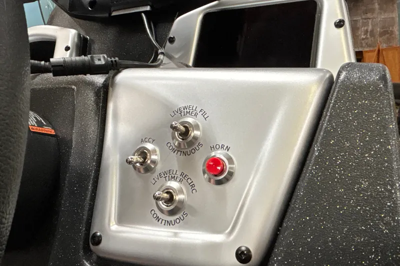 Slide: The Image of Control panel of 2027 Tracker Pro Team 175 boat with switches and red button. - 15