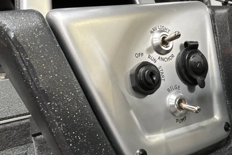 Slide: The Image of Control panel of 2027 Tracker Pro Team 175 boat with switches and ignition. - 16