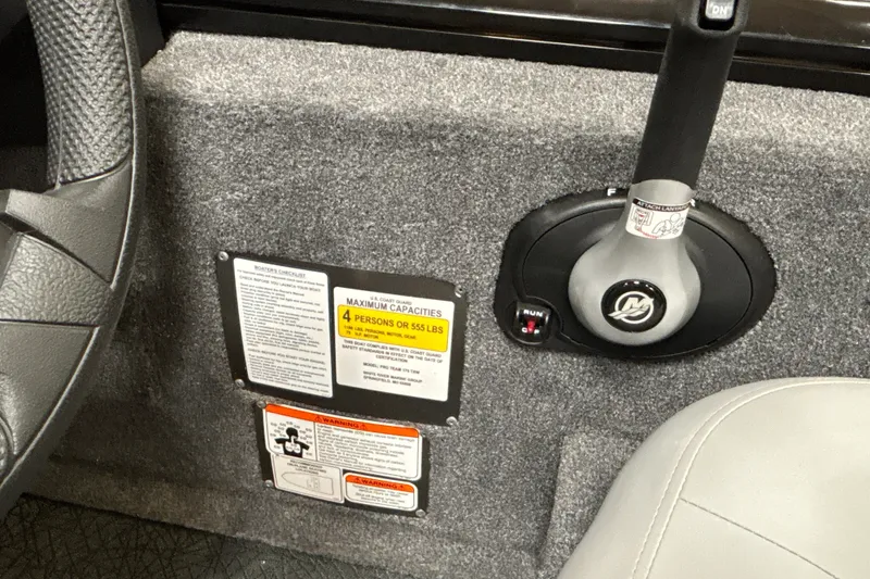 Slide: The Image of Control panel of 2027 Tracker Pro Team 175 boat with capacity warning labels. - 17