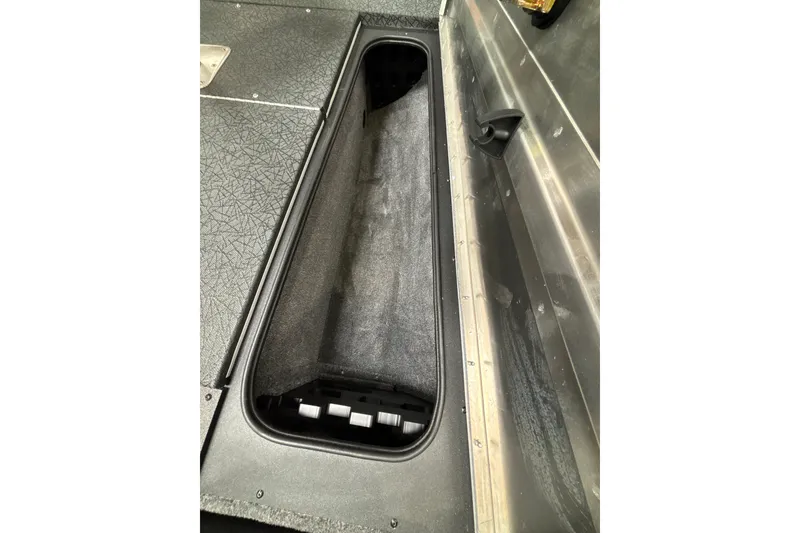 Slide: The Image of 2027 Tracker Pro Team 175 boat storage compartment with textured flooring. - 22