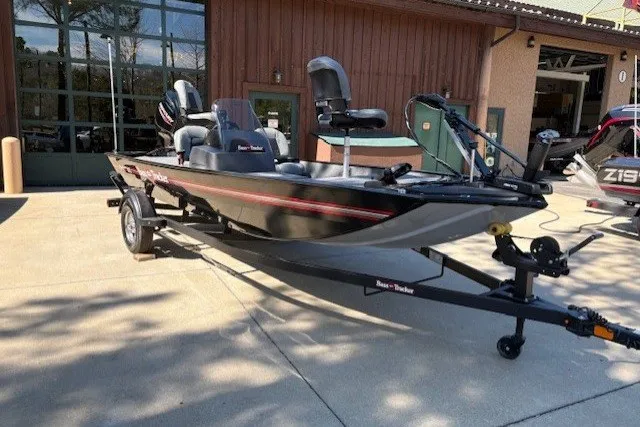 The Image of 2027 Tracker Bass Tracker Classic XL boat on trailer, parked outside a building. - 0