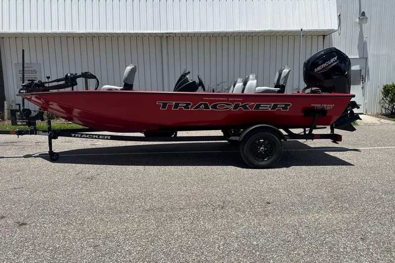 The Image of Red 2027 Tracker Pro Team 175 boat on trailer, parked outdoors. - 0