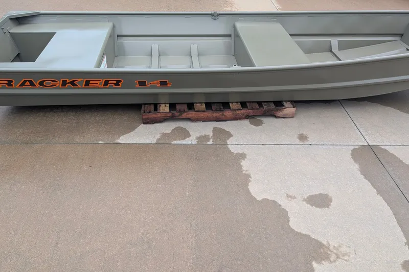 The Image of 2027 Tracker Grizzly 14 Jon boat on concrete, supported by wooden pallets. - 0
