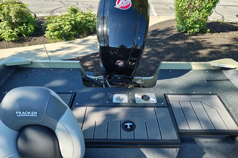 Slide: The Image of 2027 Tracker Pro Guide V-175 Combo boat interior with motor and seating. - 25