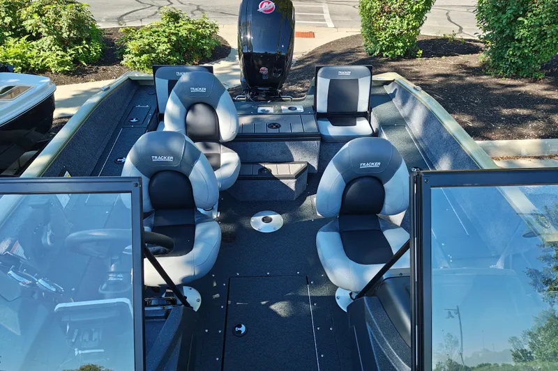 Slide: The Image of 2027 Tracker Pro Guide V-175 Combo boat interior with four seats and motor. - 20