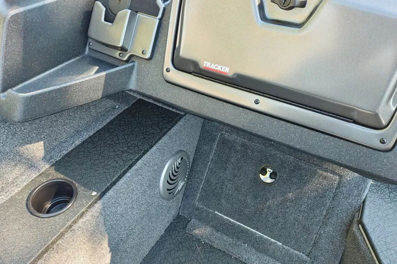 Slide: The Image of Interior of 2027 Tracker Pro Guide V-175 Combo boat, featuring storage compartments and cup holder. - 13